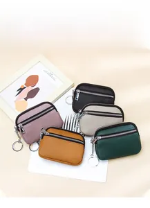 Detail of mini leather coin purses with litchi texture and silver double zippers