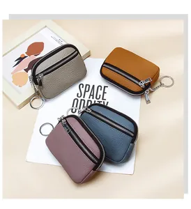 Detailed view of leather coin purses in four colors with double zippers and key rings