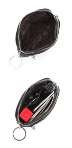 Detail view of black lychee leather mini wallet with internal pockets and metal keychain