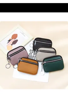 Detailed view of genuine leather coin purses with litchi texture and metal keychains