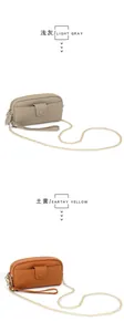 Detail of lychee pattern leather phone wallets in light gray and earthy yellow with gold chains