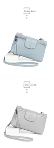 Macro shot of litchi grain genuine leather crossbody bag in aqua blue and grey white