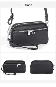 Dettaglio macro della borsa a tracolla in pelle nera con tre scomparti con zip argento