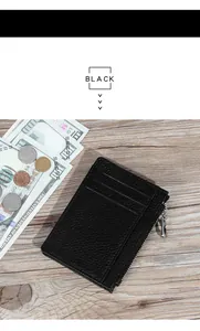 Detail of black genuine leather card holder showing lychee texture and zipper pocket