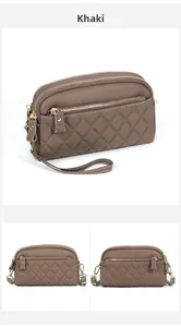 Detailed view of khaki quilted leather crossbody bag with multiple zipper compartments
