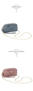 Close-up of dual-zipper leather purses in denim blue and lotus purple with gold chains