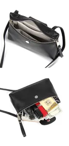 Internal view of black pebble leather crossbody bag with multiple storage compartments