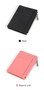 Detail view of lychee leather card holder with three slots and side zipper in black and pink
