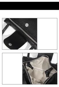 Detail of silver zipper and magnetic buckle on black lychee grain leather crossbody bag