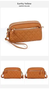 Close-up of earthy yellow quilted leather crossbody bag with triple zipper pockets