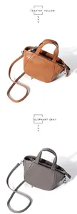 Bolsos de cuero granulado en amarillo tierra y gris elefante con asas y cremalleras plateadas