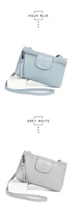 Detailed view of pebbled leather crossbody bags in aqua blue and grey white colors