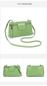 Detail of avocado green litchi grain leather crossbody bag with metal zipper and strap