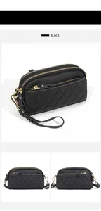 Detail of black quilted genuine leather crossbody bag with triple gold-tone zippers