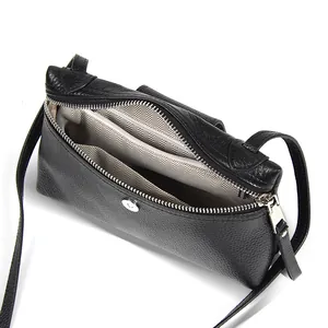 Minimalist black lychee pattern leather crossbody bag with spacious interior compartments