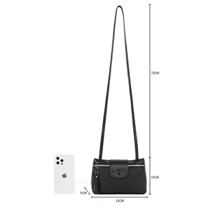 Minimalist black pebble leather crossbody bag with dimensions and phone size comparison