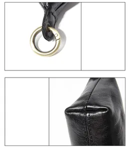 Détail du porte-monnaie en cuir noir avec fermoir doré et coutures de haute qualité