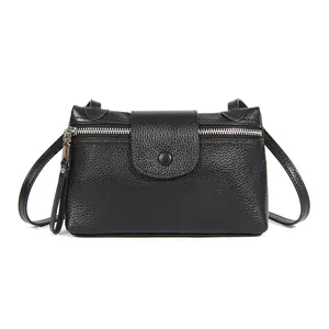 Minimalist black leather crossbody bag for women with pebble texture and silver zipper