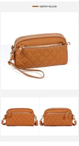 Detail of earthy yellow quilted leather crossbody bag with multiple zippers and gold hardware
