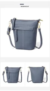 Makro-Detail der denimblauen Eimer-Tasche aus genarbtem Leder mit weißen Kontrastnähten