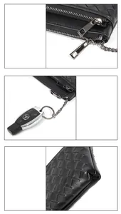 Detail view of woven sheepskin coin purse featuring double zippers and a metal key ring