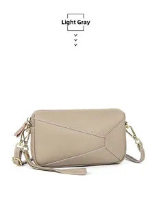 Detail of light gray leather handbag featuring lychee texture and geometric stitching