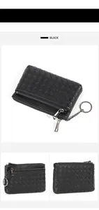 Detailed view of black hand-woven sheepskin coin purse with dual zippers and keychain