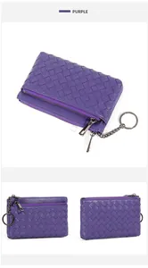 Macro detail of hand-woven purple leather wallet featuring double zippers and key ring