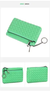 Detail view of woven green leather coin purse with zipper closure and metal keychain