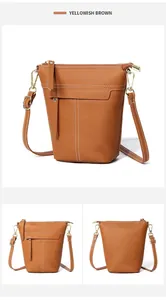 Makroansicht der gelbbraunen Eimer-Tasche aus Kieselleder mit weißen Kontrastnähten