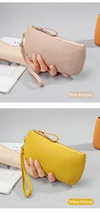 Detail of pink and yellow pebble leather wristlets showing fine grain texture and zipper