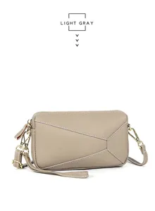 Macro detail of light gray genuine leather crossbody bag with geometric stitching