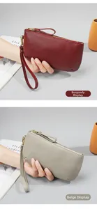 Detail of wine red and beige grey genuine leather clutches with pebble grain texture