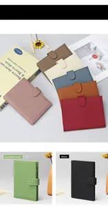 Detailed view of the snap closure and lychee grain texture on leather passport wallets