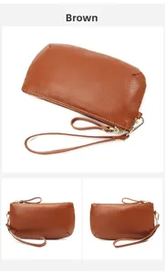 Macro shot of brown pebble grain leather wallet with gold zipper and wristlet strap