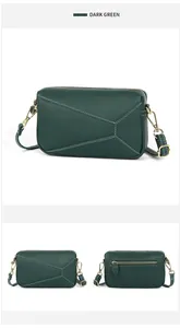 Detail of dark green leather crossbody bag with geometric stitching and gold hardware