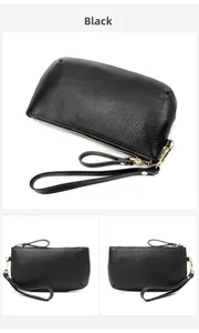 Detail view of black pebbled leather wristlet clutch with gold hardware and zipper
