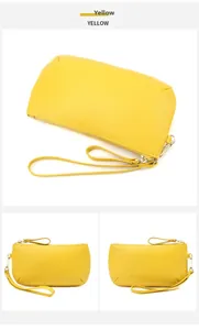 Macro view of yellow lychee grain leather wallet with gold zipper and wrist strap