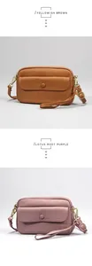 Detail view of lychee grain leather crossbody bags in yellowish brown and lotus purple