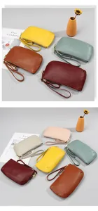 Close-up of pebble grain leather texture and golden zippers on colorful wristlet bags