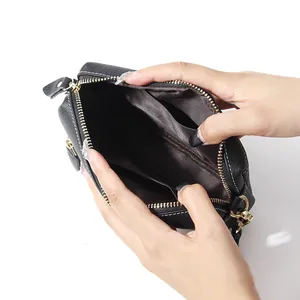 Black pebbled leather crossbody bag with multiple compartments and gold hardware detail
