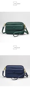 Detail view of Dark Green and Dark Blue leather crossbody bags with pebbled texture