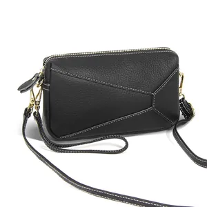 Fashionable black leather crossbody bag with geometric stitching and gold hardware