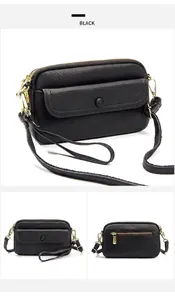 Detail of black pebbled leather crossbody bag with gold hardware and snap closure