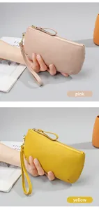 Detail of pink and yellow leather wristlet purses with premium pebble grain and gold zippers