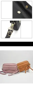 Close-up of litchi grain leather crossbody bag with magnetic buckle and gold hardware