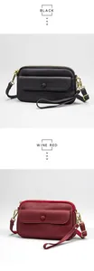 Detail of leather crossbody bags in black and wine red with gold metal hardware