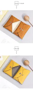 Close-up of pebble grain leather coin purses in biscuit and yellow with metal snaps