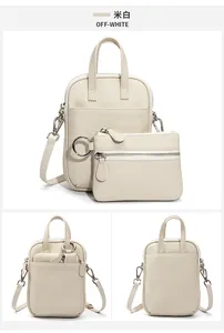 Detail view of off-white lychee grain leather crossbody bag set with small coin purse pouch