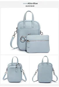 Detail of Alice Blue leather crossbody bag with matching zipper pouch and silver hardware